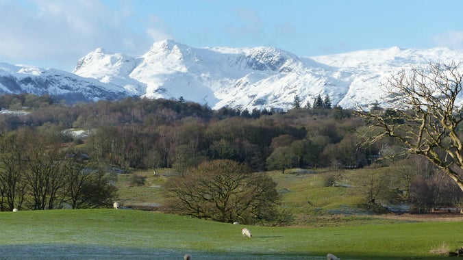 View of the snow capped mountain peaks of the Langdales taken in the grounds of Wray, Cumbria